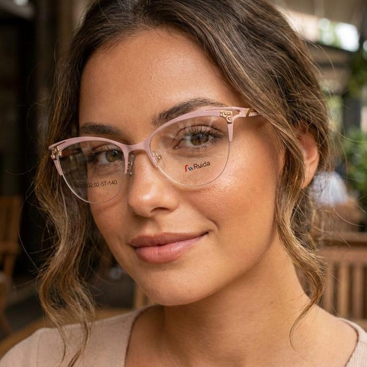 Woman wearing pink glasses with a blurred outdoor background